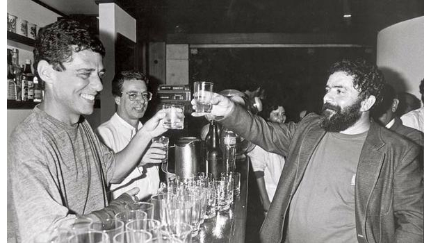 Chico Buarque e Lula da Silva numa fotografia quando os dois ainda eram mais jovens. A aliança entre o artista e o petista é antiga e, por certo, o autor de “Construção” pretende mantê-la. Ao fundo, também brindando, aparece Frei Betto, religioso de esquerda e amigo íntimo do petista | Divulgação