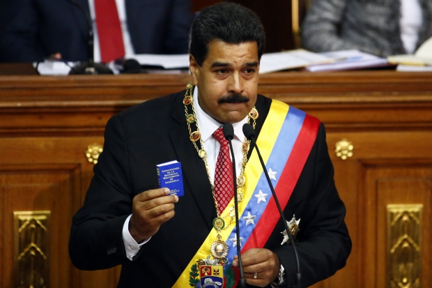 REFILE - CORRECTING HEADLINE Venezuelan President Nicolas Maduro speaks at the National Assembly in Caracas October 8, 2013. Maduro was going to parliament on Tuesday to seek decree powers he says are needed to tackle corruption and fix the economy but opponents view as proof he wants to rule as an autocrat. The National Assembly, where Maduro's socialist government has a nearly two-thirds majority, is widely expected to grant him the fast-track legislative powers in a revival of a measure used several times by his predecessor, Hugo Chavez. REUTERS/Jorge Silva (VENEZUELA - Tags: POLITICS)