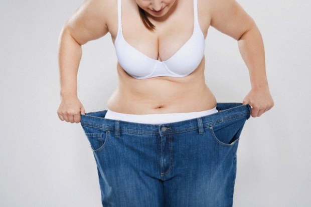 Young chubby woman with oversized pant --- Image by © Philipp Dimitri/Westend61/Corbis