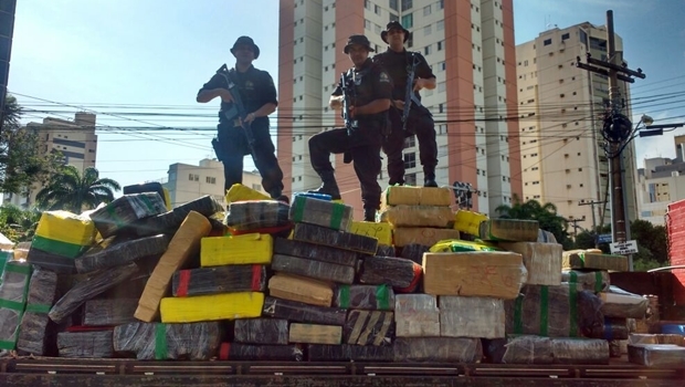 Policiais mostram o carregamento da droga encontrada no galpão no setor | Foto: Divulgação PM5