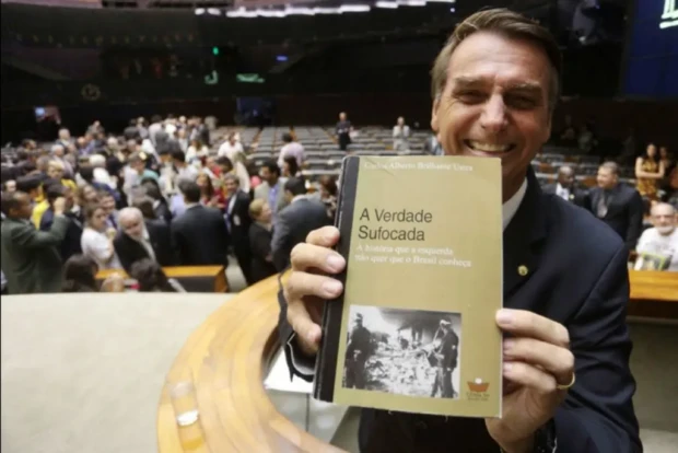 Jair Bolsonaro e foto de livro de Brilhante ustra