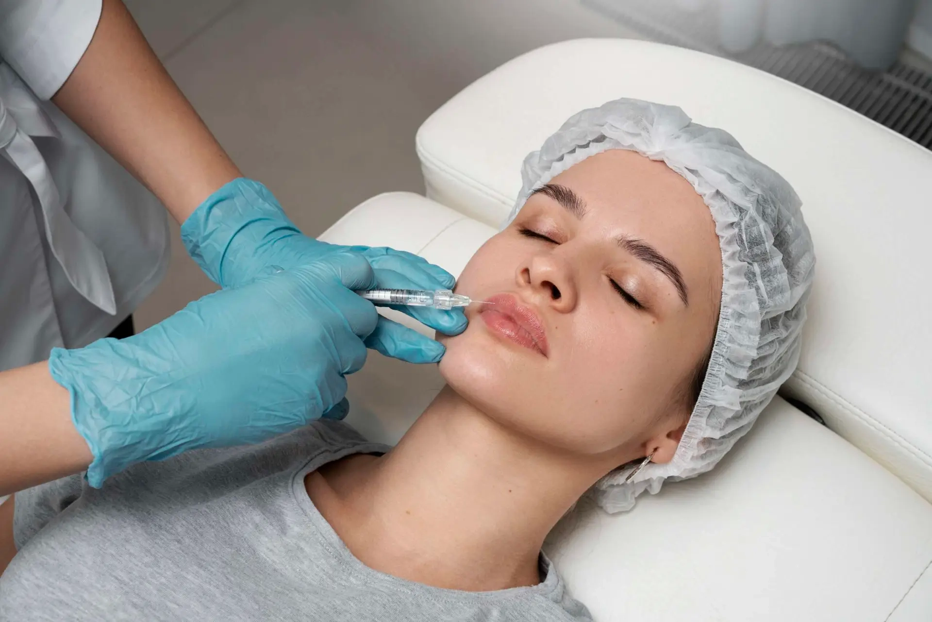 high-angle-woman-getting-lips-injection-scaled